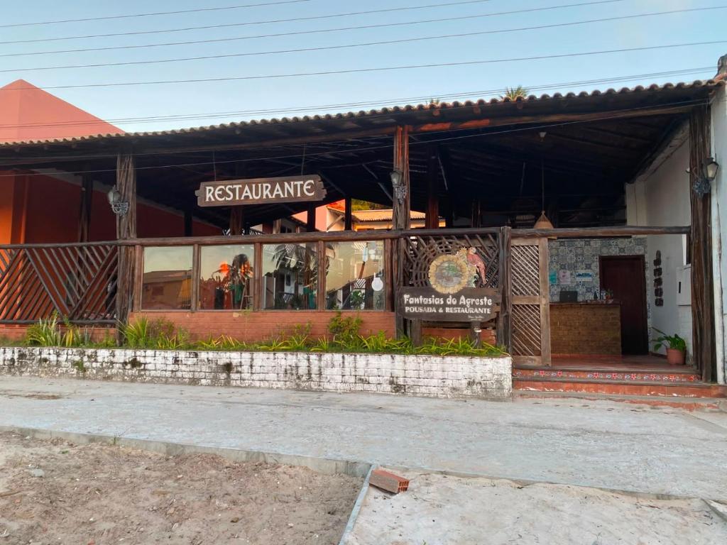 a restaurant with a sign in front of a building at Fantasia do Agreste in Jandaíra