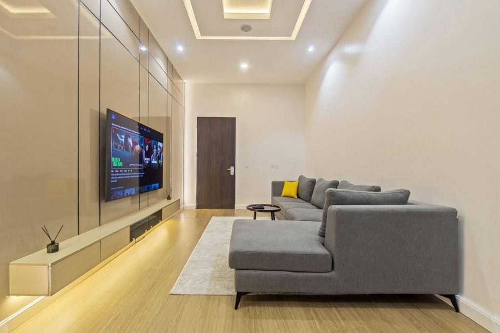 a living room with a couch and a flat screen tv at Zuma Tan in Lagos