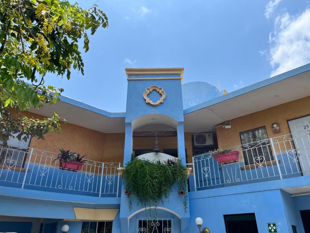 a building with a clock on the front of it at Hotel Hacienda del Viejo in Matamoros