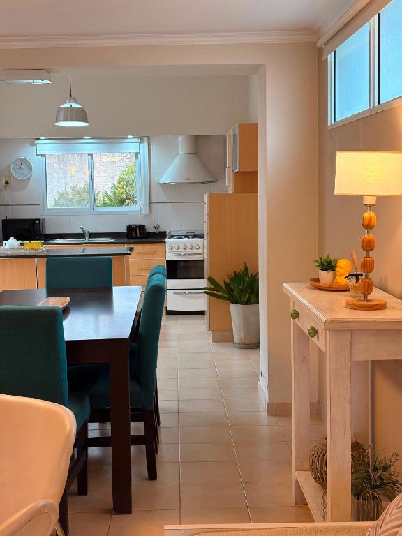 a kitchen and dining room with a table and chairs at Rancho nuevo in Carhué