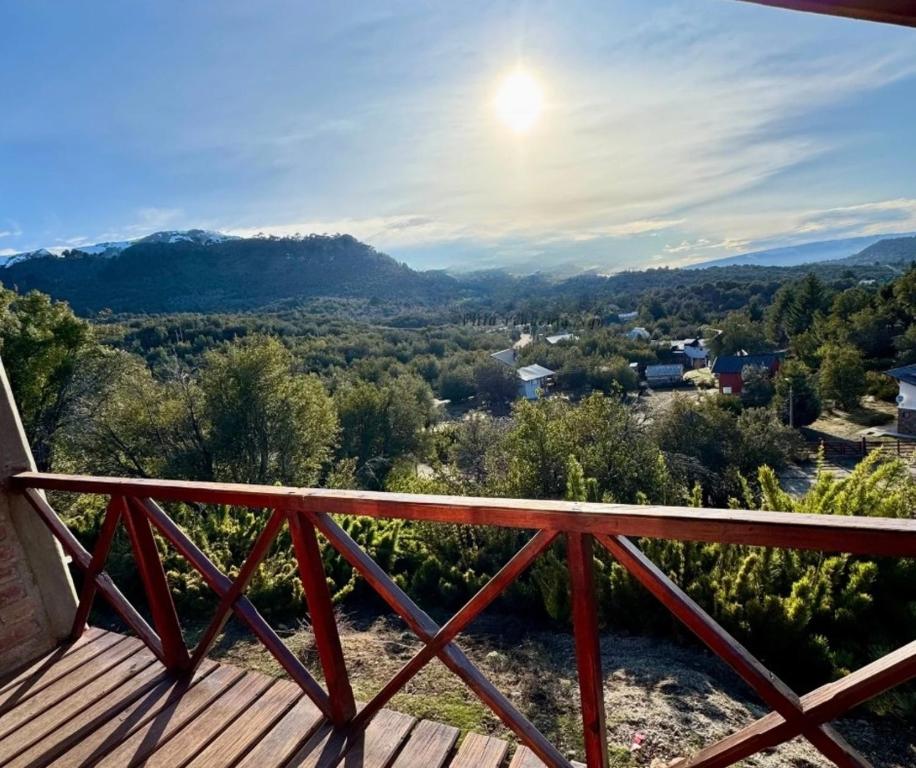 a view from a deck with the sun in the sky at Selene Malen 5 in Villa Pehuenia