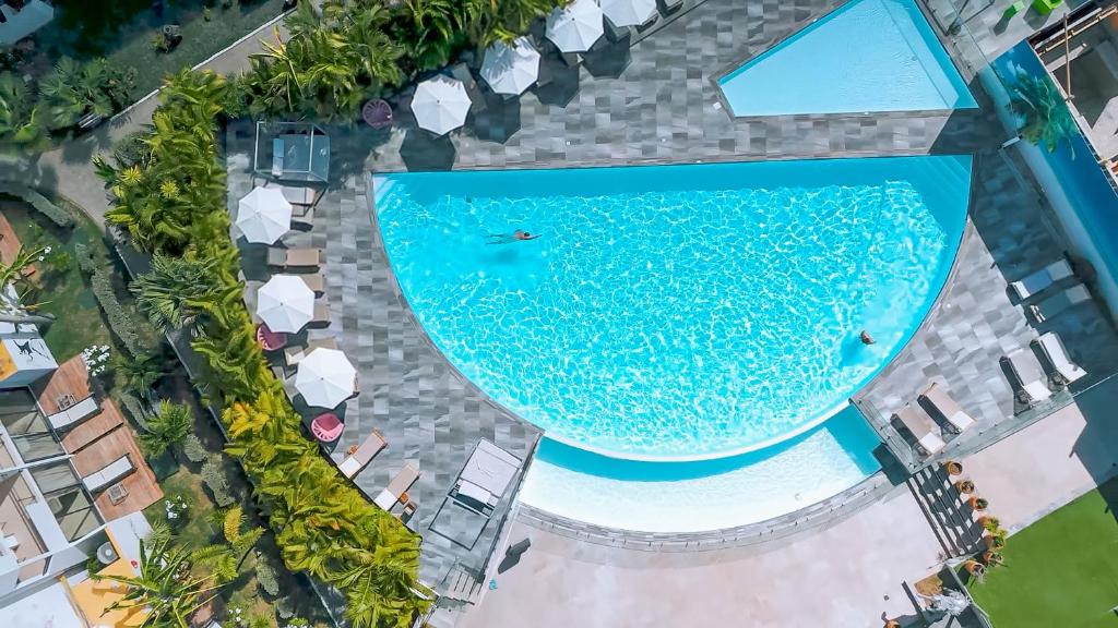 an overhead view of a pool at a resort at Hommage Hotel & Residences in Baie Nettle