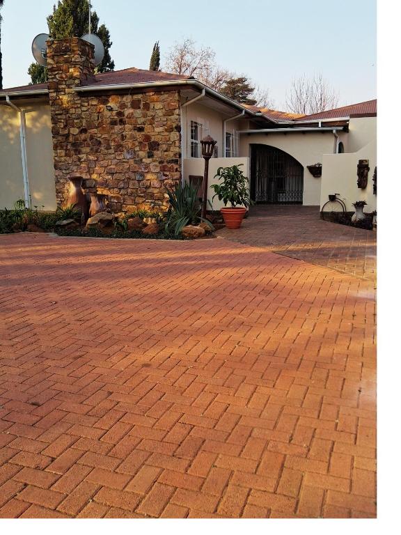 a brick driveway in front of a house at 30 on Latham Guesthouse in Klerksdorp