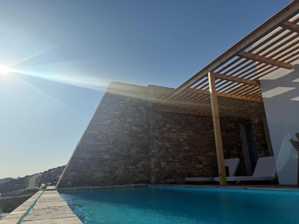 a house with a swimming pool next to a building at 2-bedroom villa Odysseus in Antiparos