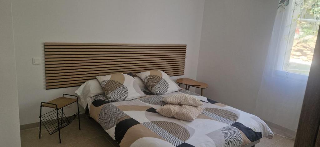 a bedroom with a bed and two chairs and a window at L'ecrin de Provence in Beaumes-de-Venise