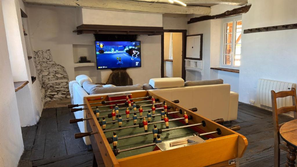 a living room with a foosball table at Les Vieilles Planches in Pampelonne