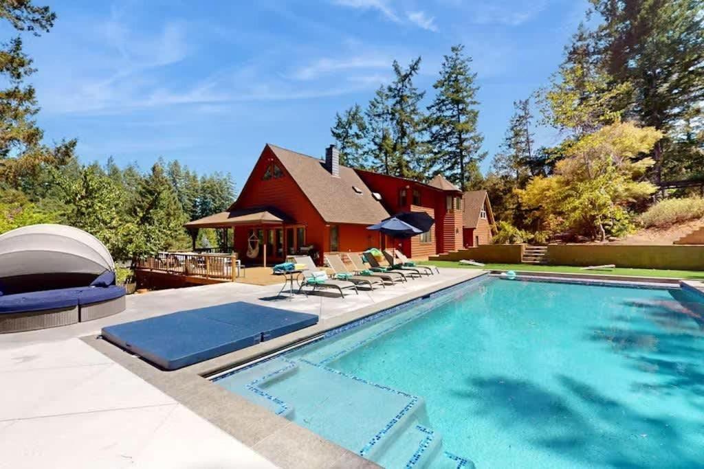 a house with a swimming pool and a red barn at Sunny Grove Retreat in Sebastopol