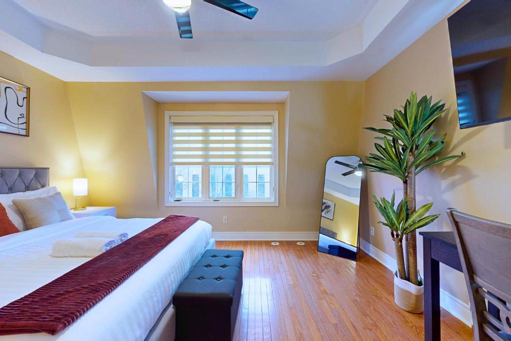 a bedroom with a bed and a plant in it at Private Rooftop Group Suite near Oriole Park - Eglinton Hotel in Toronto