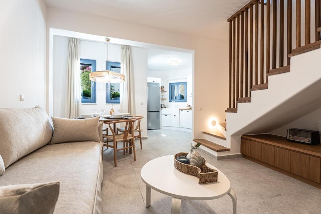 a living room with a couch and a table at Terraegea Paros in Dhragoulás