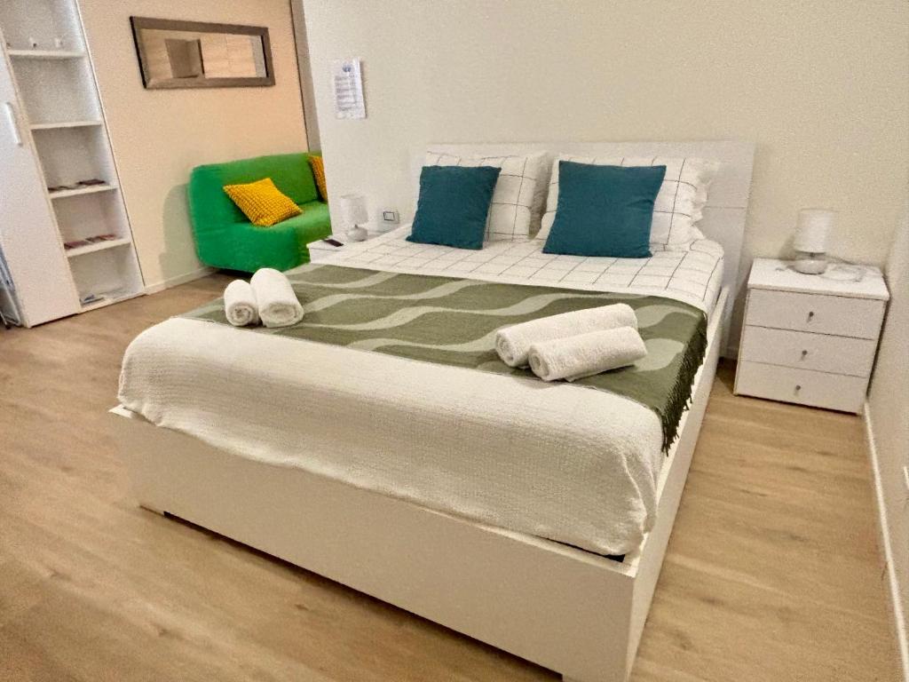 a bedroom with a large bed with blue and green pillows at Sky House Sant'Orsola in Bergamo