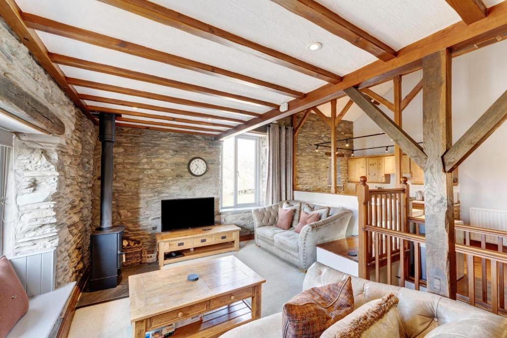 a living room with a couch and a tv at 2 Bed in Ambleside oc-lr177 in Ambleside