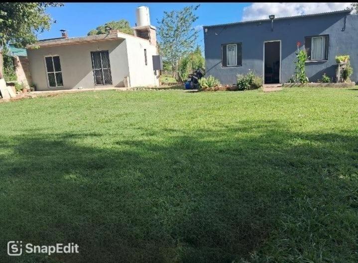 a house with a large lawn in front of it at Villarrica in Valle Hermoso