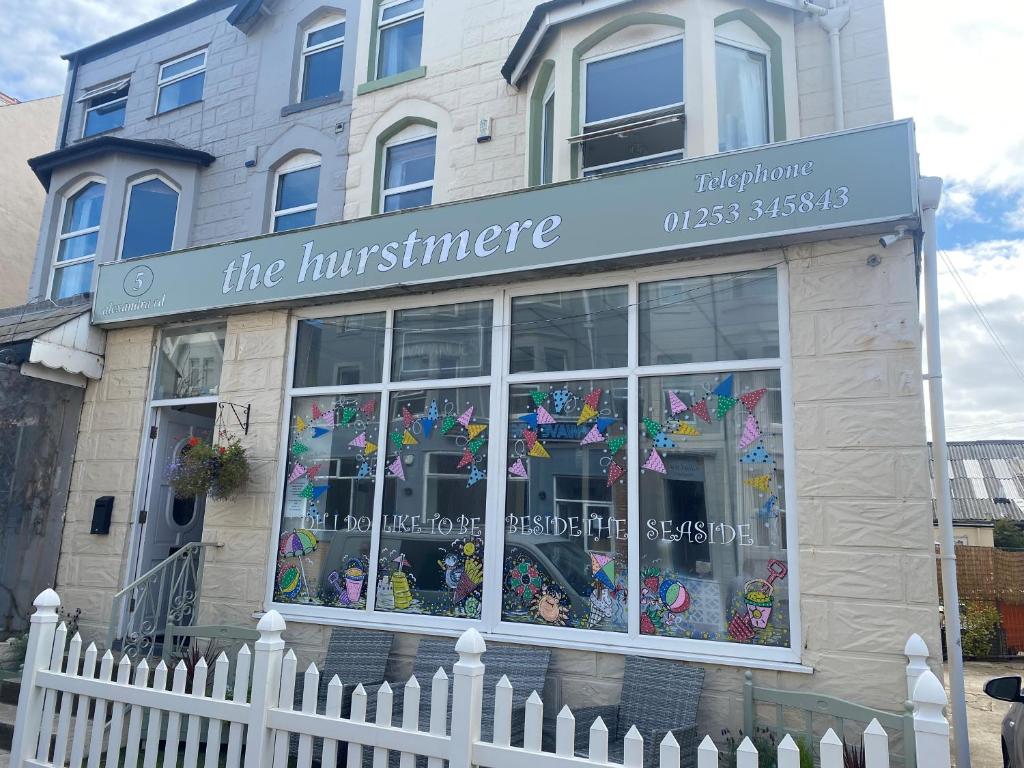 a store with a white fence in front of a building at The Hurstmere in Blackpool