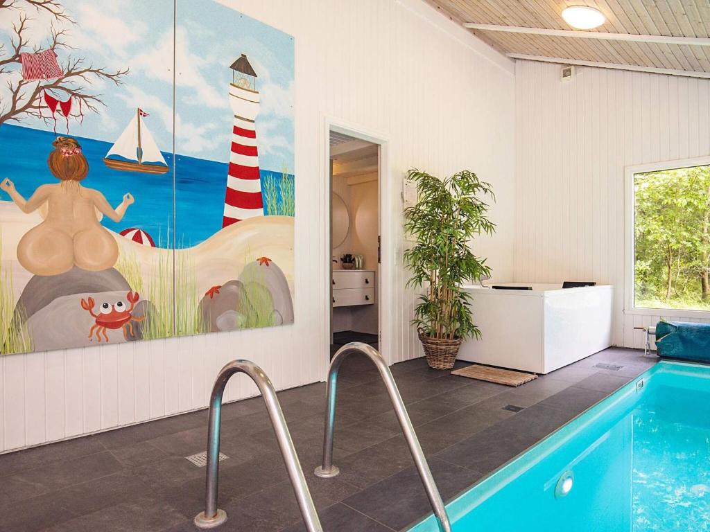 a room with a pool and a painting on the wall at 5 star holiday home in Bindslev in Bindslev
