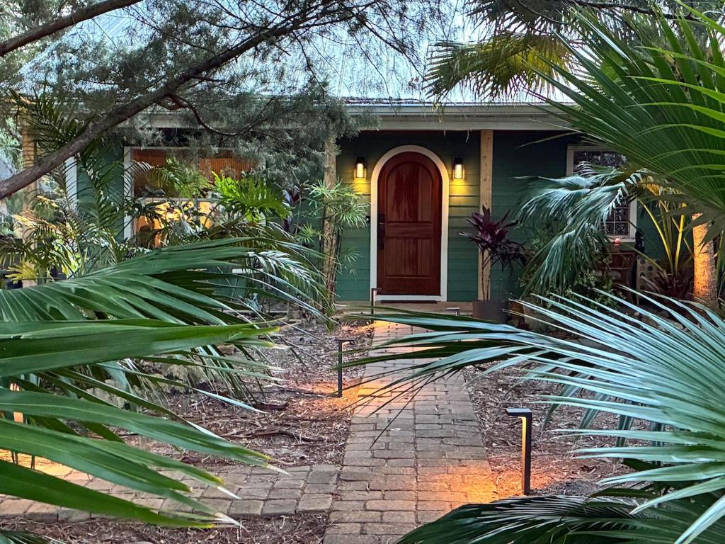 a house with a green door and some plants at The Sebastian Surf Lodge in Vero Beach