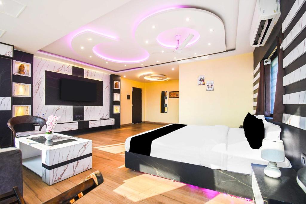a bedroom with a bed and a flat screen tv at Townhouse Hirak Road Dhanbad in Dhanbād