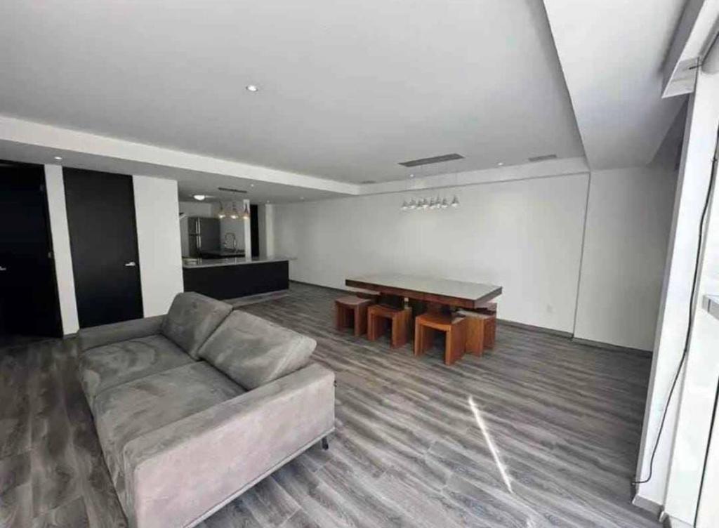 a living room with a couch and a table at tulum in Tulum