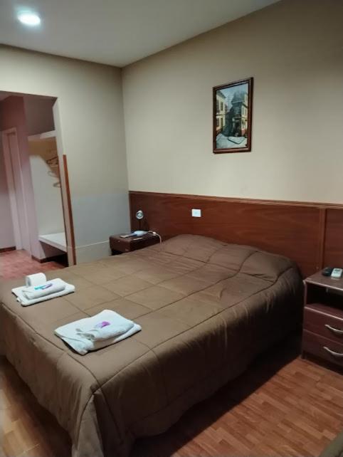 a bedroom with a bed with two towels on it at Hotel Nerja in San Juan