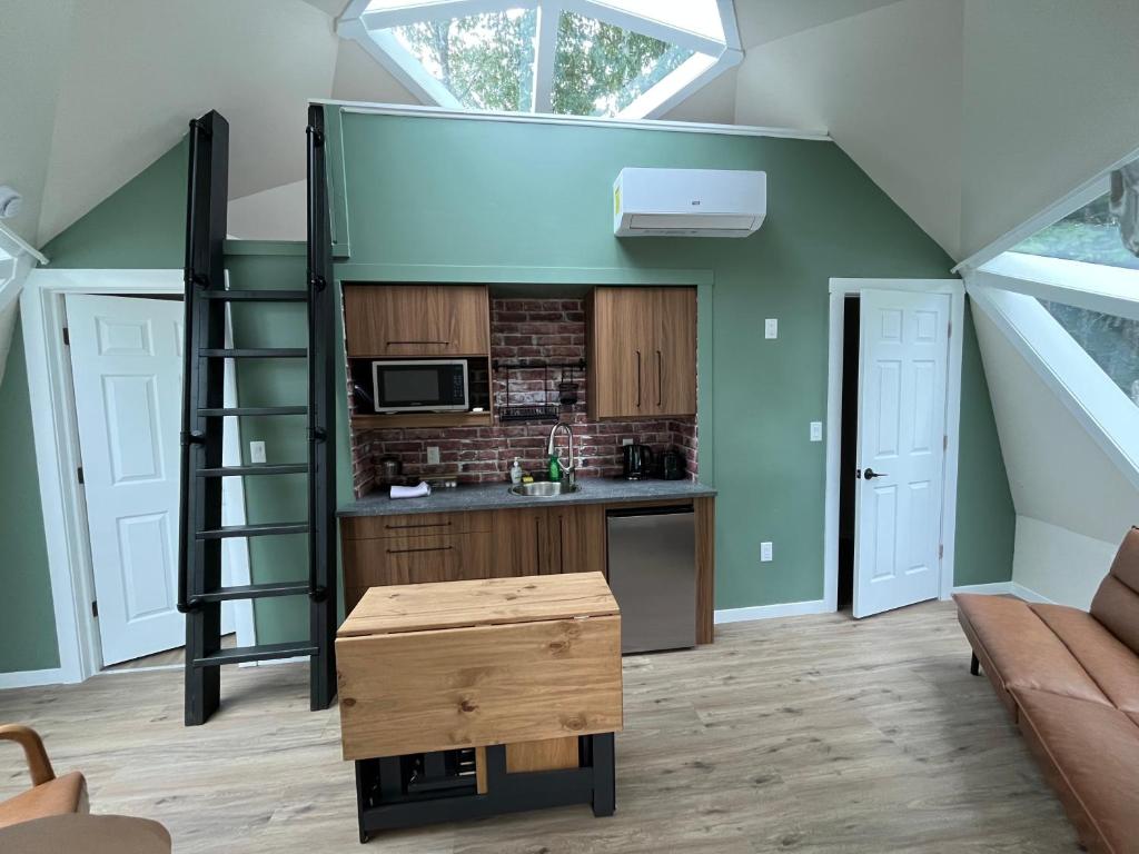 a loft conversion with a kitchen and a living room at Blue Bayou Dome cottages in Dingwall