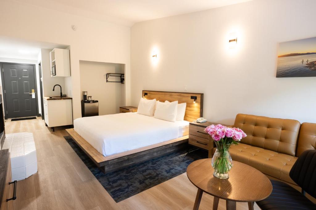 a hotel room with a bed and a couch at Sunshine Lodge Inn in Gibsons