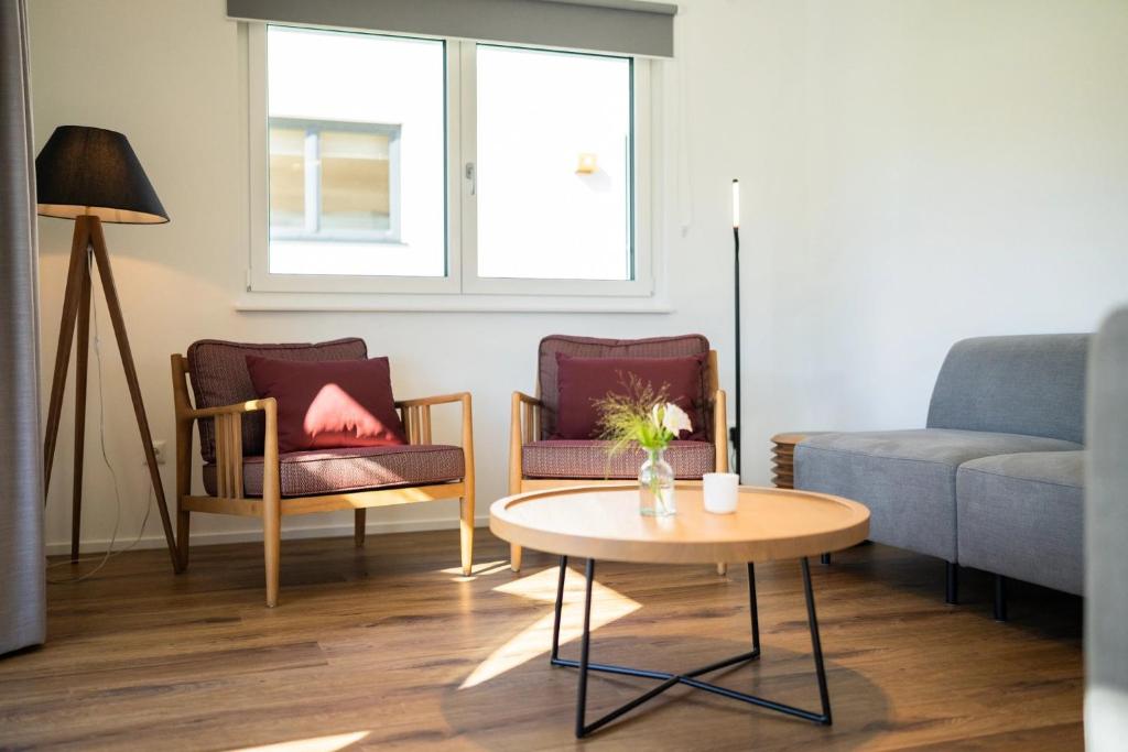 a living room with a couch and a table at Landal Arber in Zwiesel