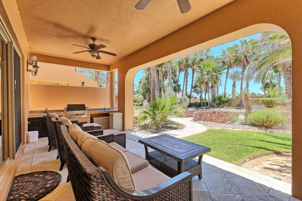 an outdoor patio with wicker chairs and a table at Bella Sirena Villa 8 - Your Dream Coastal Escape in Puerto Peñasco