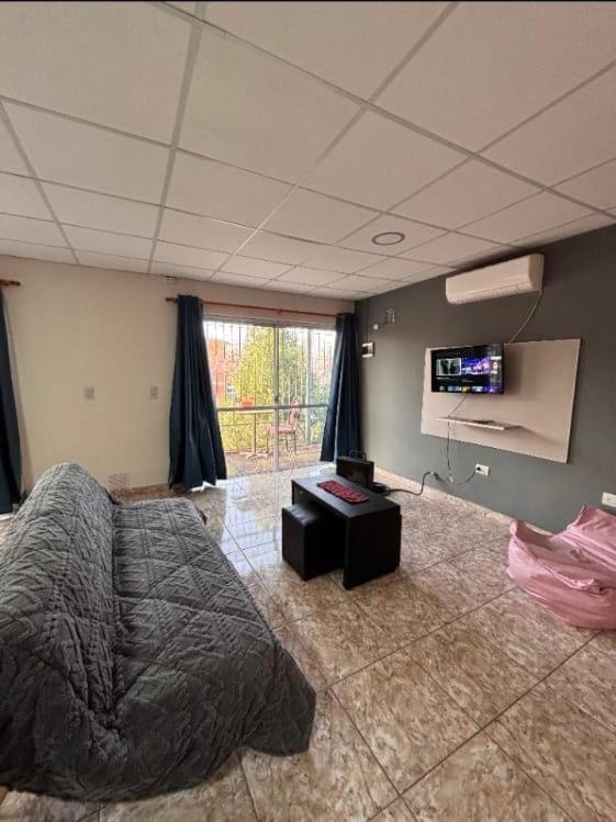 a bedroom with a bed and a flat screen tv at Aires de Mendoza in Maipú