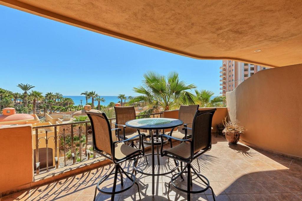 a balcony with a table and chairs and the ocean at Sandy Beach Rocky Point Bella Sirena 203-E in Puerto Peñasco