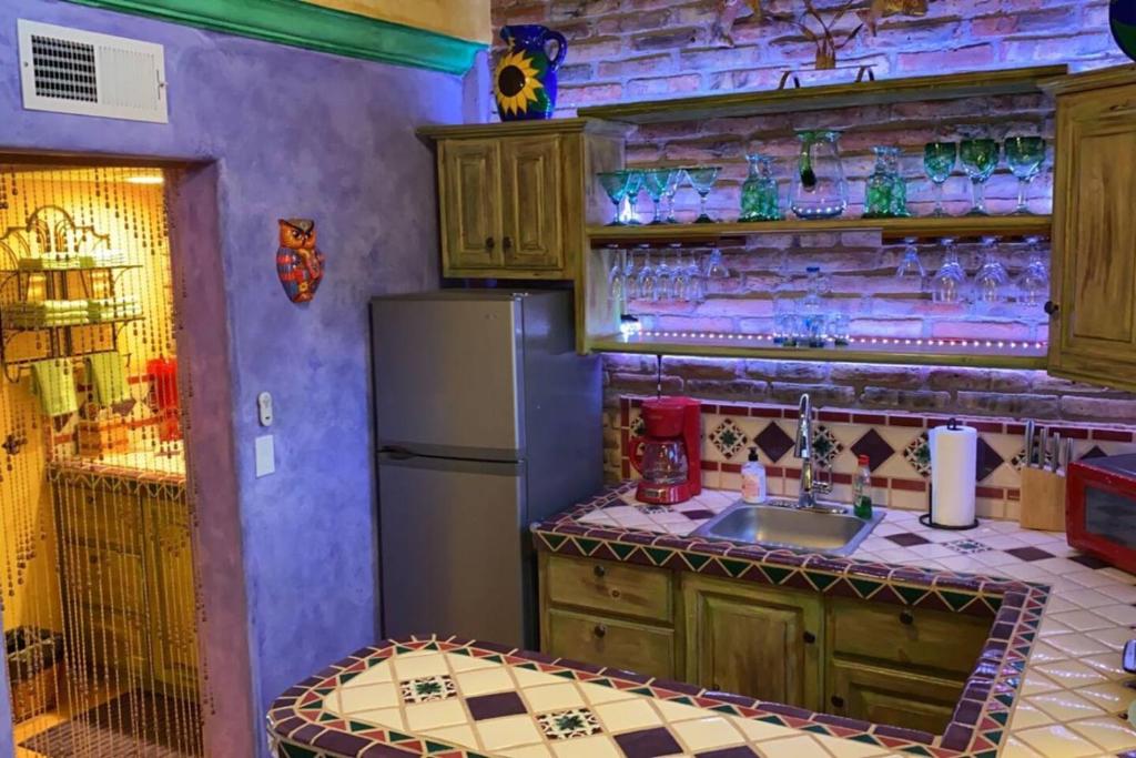 a kitchen with a sink and a refrigerator at Loft with rooftop deck in the Malecon - Unit #206 in Puerto Peñasco
