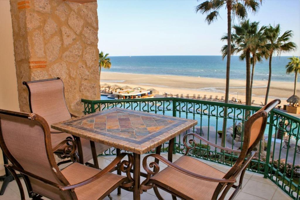 a table and chairs on a balcony overlooking the beach at Sonoran Sea 310-W - Modern 1 bedroom in Puerto Peñasco