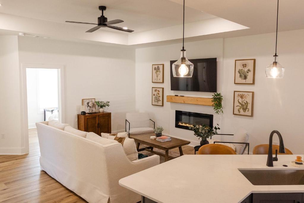 a living room with white furniture and a fireplace at Pensacola Florida in Pensacola