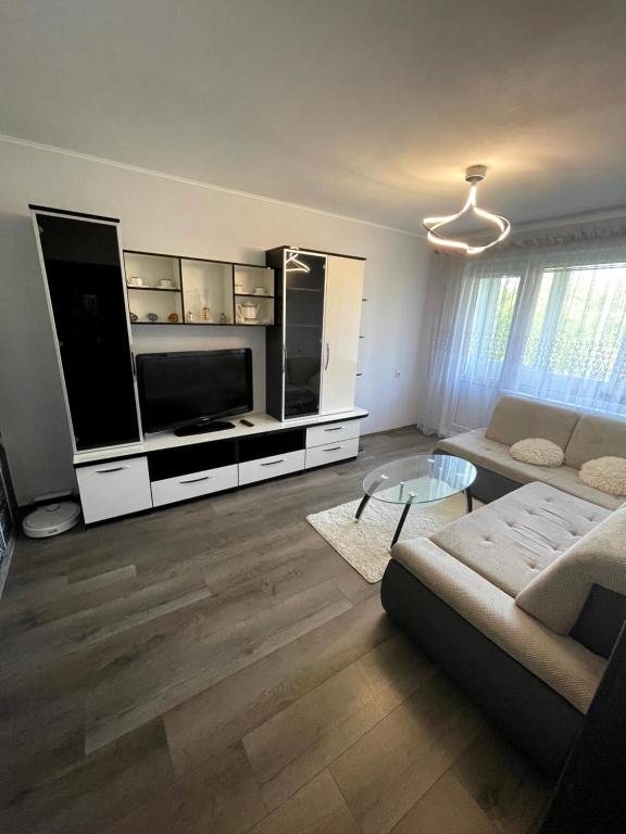 a living room with a flat screen tv and a couch at Klaipeda City in Klaipėda