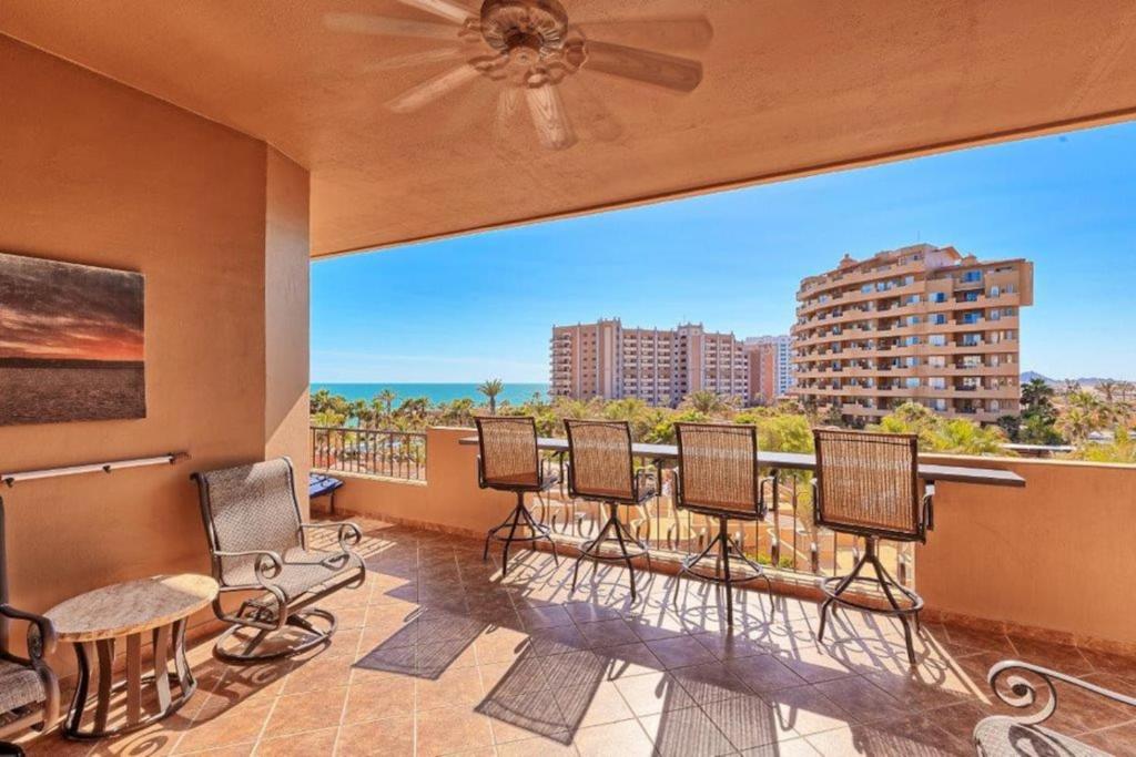 a balcony with chairs and a view of the ocean at Bella Sirena 305-A - Elegant Oceanview Condo on Beachfront Resort in Puerto Peñasco