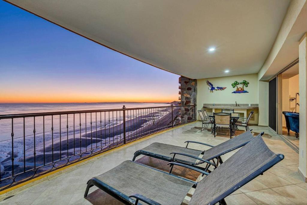 a balcony with chairs and a view of the ocean at Sonoran Sky 1102 Luxury with Views! in Puerto Peñasco