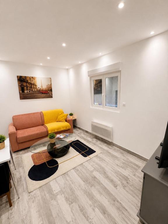 a living room with a couch and a table at Studio Zoo & Châteaux in Faverolles-sur-Cher
