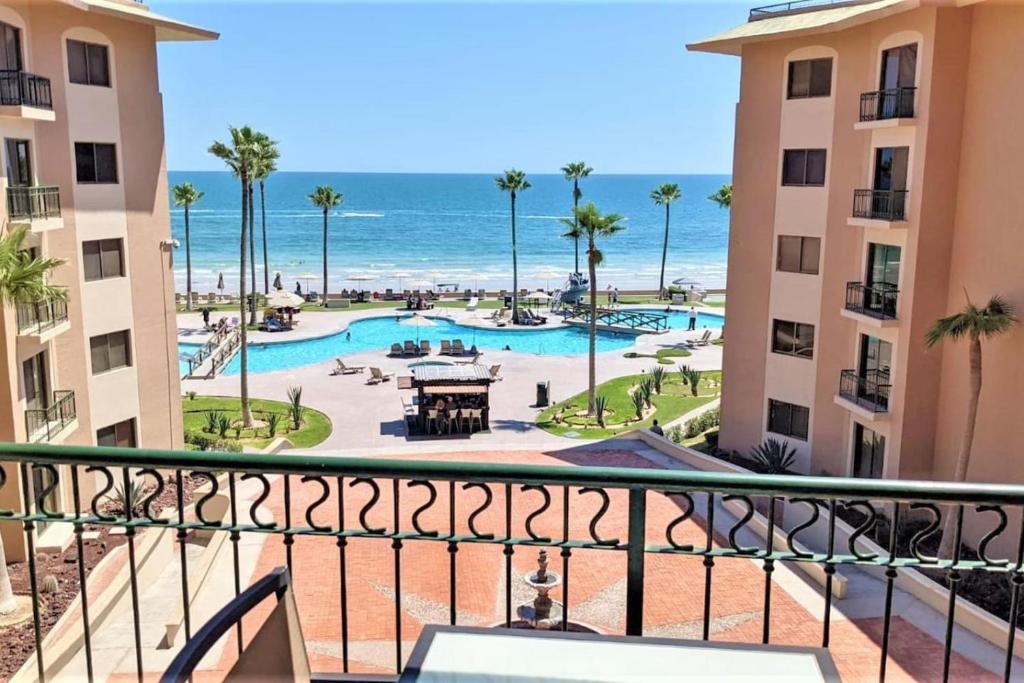 a view of the beach from the balcony of a resort at Sonoran Spa 304-N in Puerto Peñasco