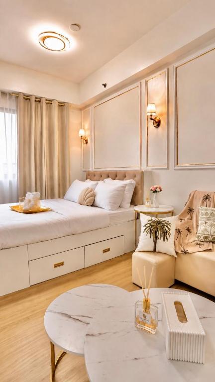 a bedroom with two beds and a couch at LuxeInn in Trece Martires