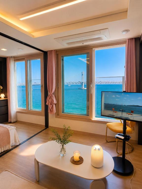 a living room with a view of the ocean at Crystal Ocean House 무료주차 in Kwangan-dong