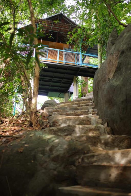a bridge over some stairs in front of a building at Glen Brooks Resorts in Calicut
