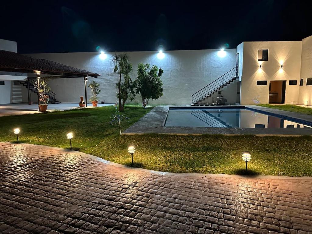 a house with a swimming pool at night at Natura suite's & eventos in Guadalajara