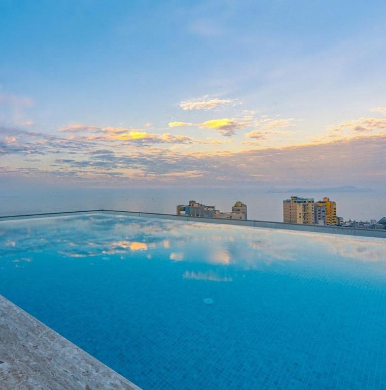 a large blue swimming pool on top of a building at SOUMA Hotel, Vignette Collection by IHG in Lima