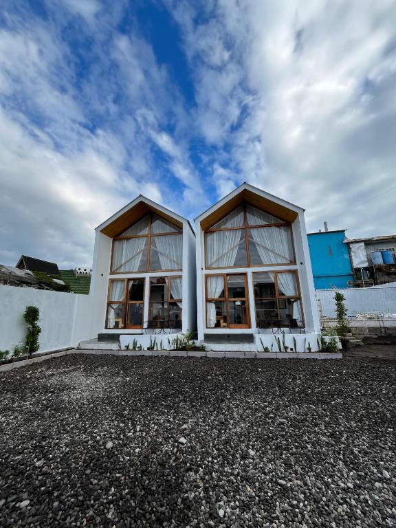 a building with two large windows on the side of it at Asokabin House in Diyeng