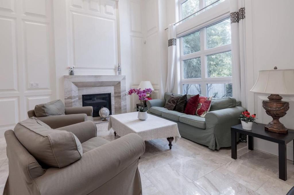 a living room with two couches and a fireplace at Private Room in Richmond in Richmond