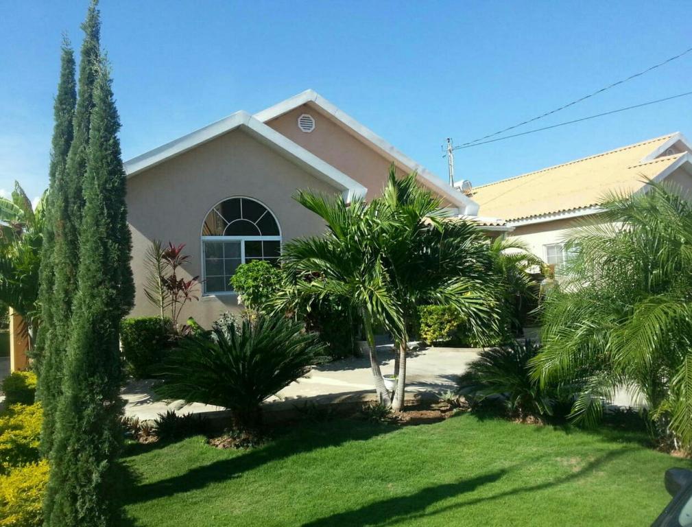 a house with palm trees in a yard at Caribbean Estate AJ in Portmore