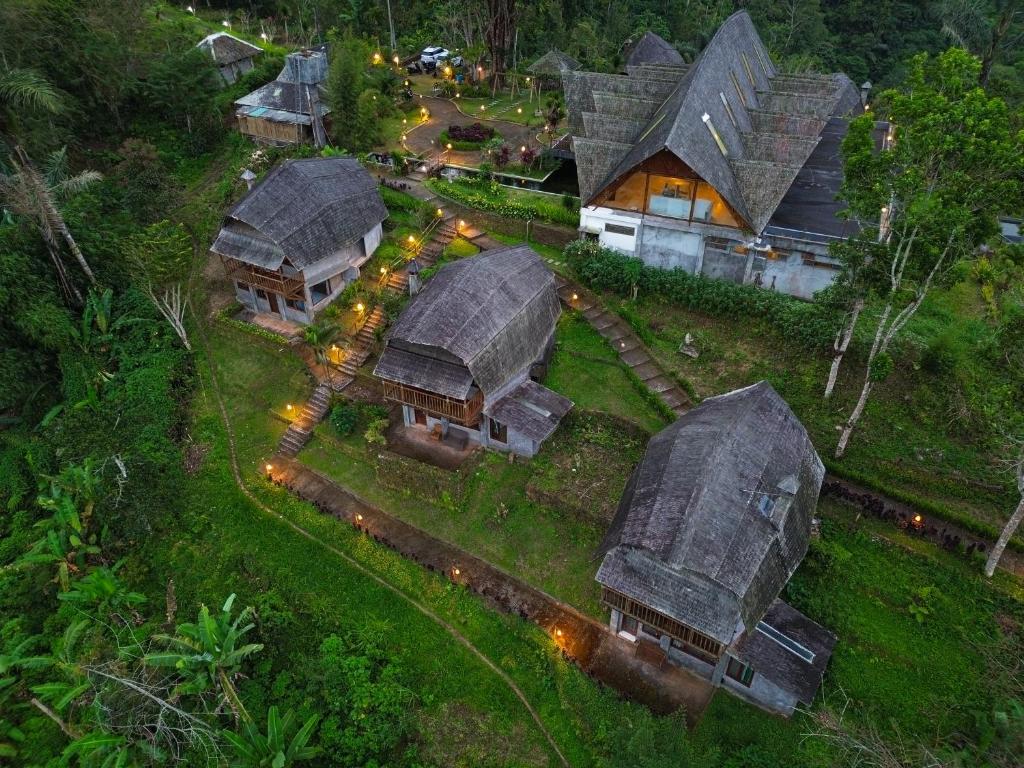 an overhead view of a group of houses with roofs at Plaga Eco Village by Nabe Hospitality Management in Plaga
