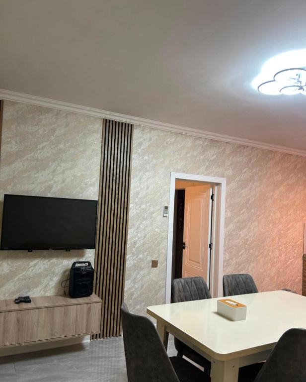 a room with a table and chairs and a bed at Rewad villa in Gabala