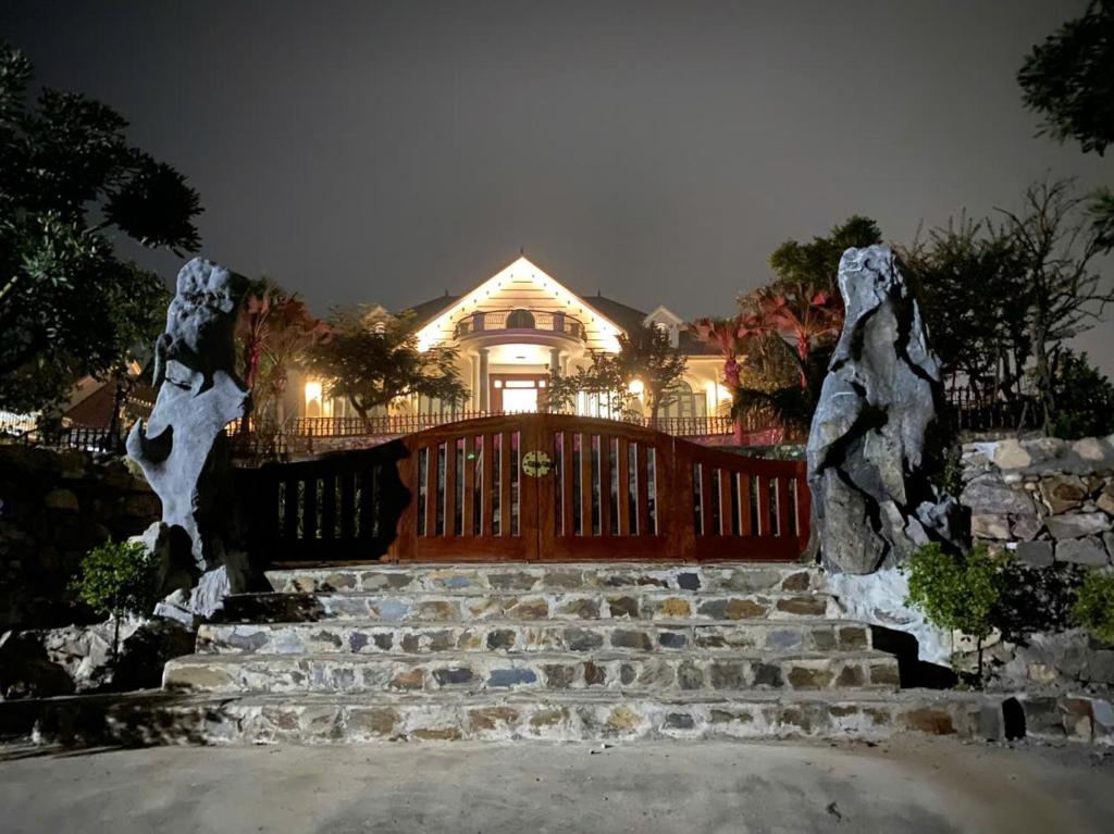 a house with a set of stairs in front at Sunstone Villa in Trung Gia