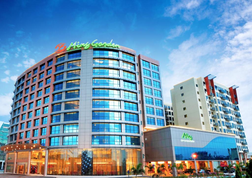 a tall building with a sign on top of it at Ming Garden Hotel in Kota Kinabalu