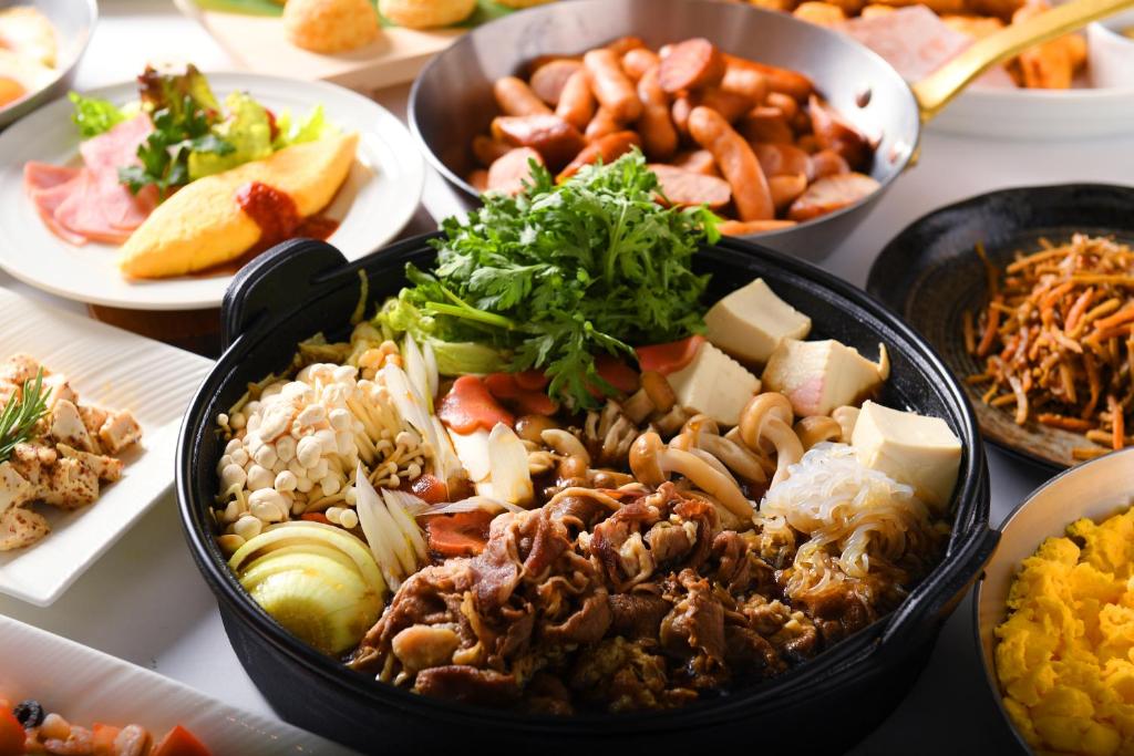 a table with many different types of food on it at Hotel Plaza Kobe in Kobe