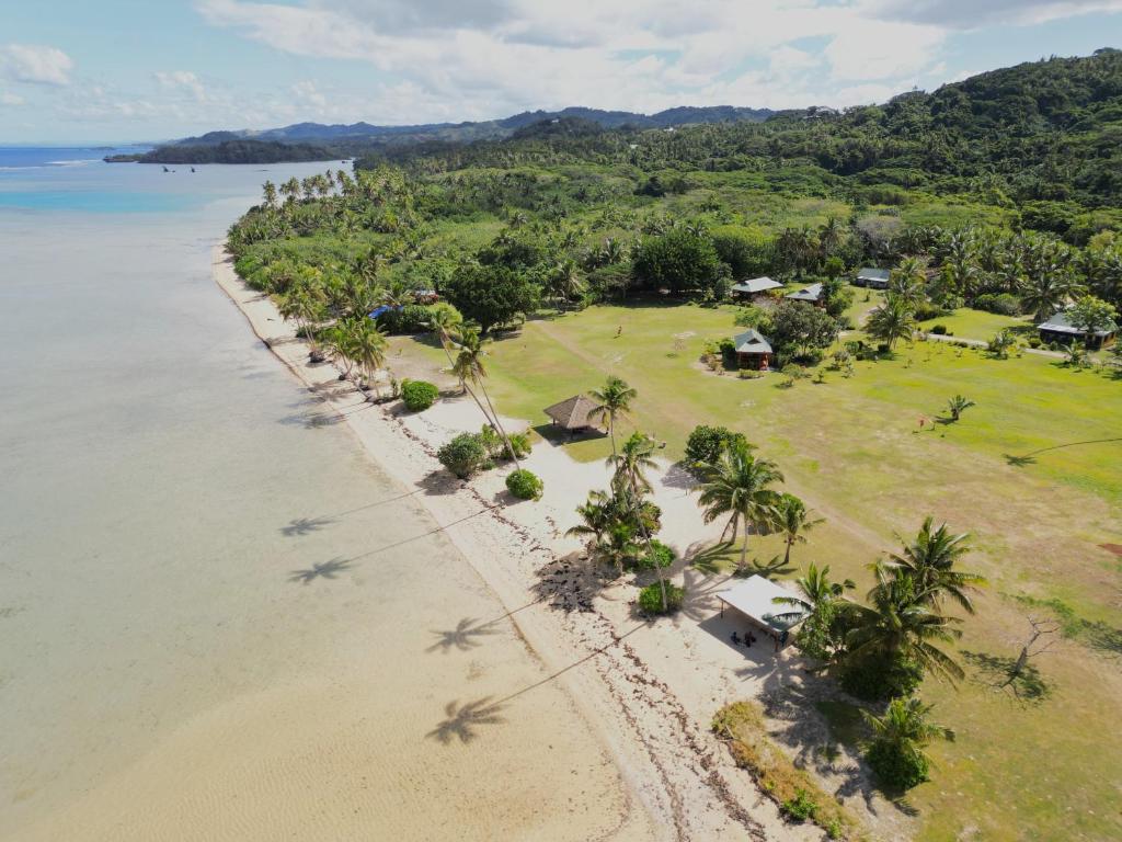 an aerial view of a beach with palm trees at Sigasiga Sands Boutique Bungalows in Savusavu